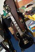 A 2006 EPIPHONE LES PAUL CUSTOM GUITAR, in black and gold serial number EE 061008702 (Condition