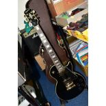 A 2006 EPIPHONE LES PAUL CUSTOM GUITAR, in black and gold serial number EE 061008702 (Condition