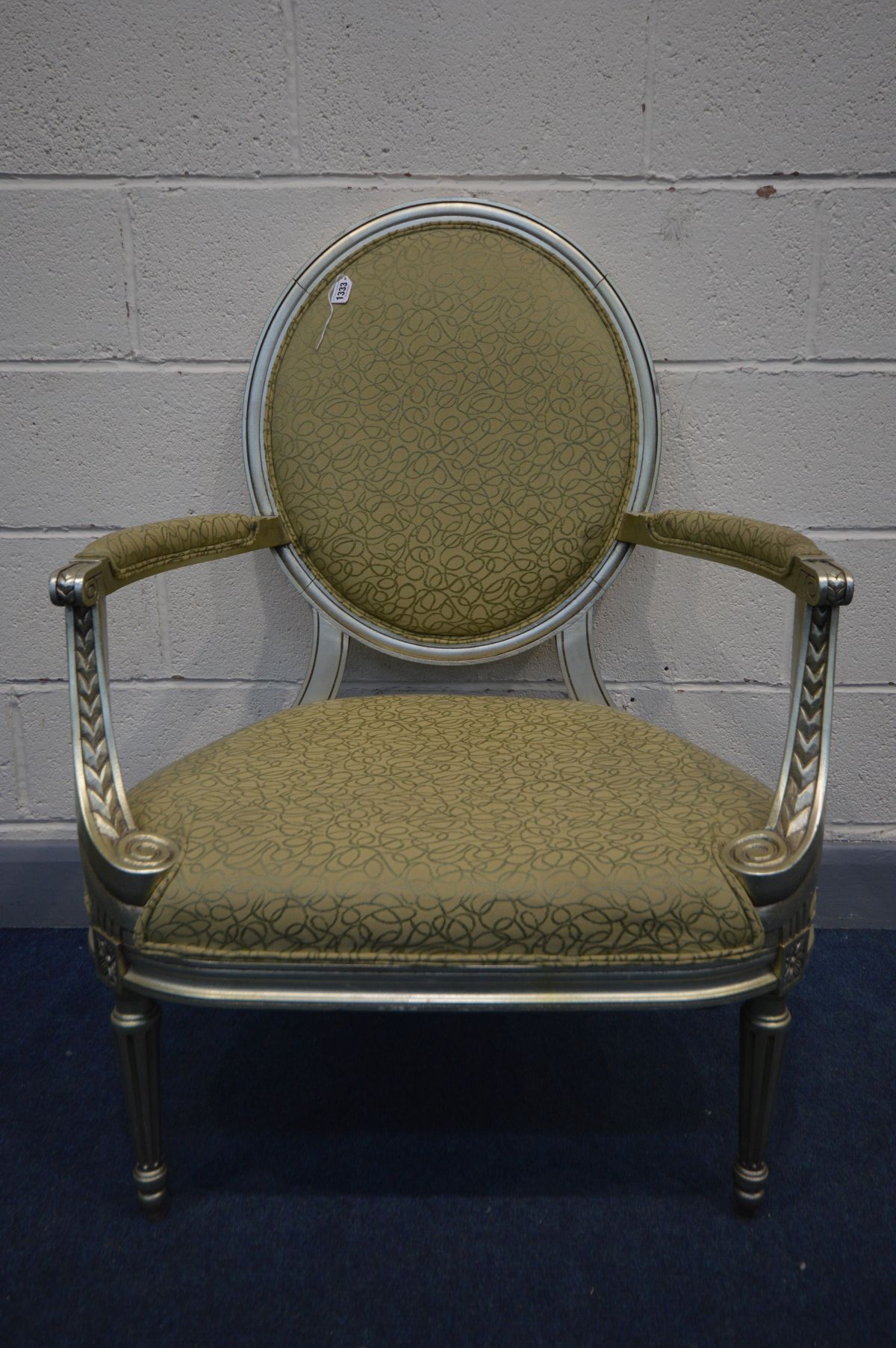 A REPRODUCTION LOUIS XVI STYLE OPEN ARMCHAIR, circular back, silver painted and patterned