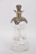 AN EDWARDIAN GLASS AND SILVER DECANTER, the hour glass bottle with silver collar and stopper