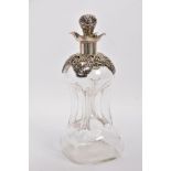 AN EDWARDIAN GLASS AND SILVER DECANTER, the hour glass bottle with silver collar and stopper