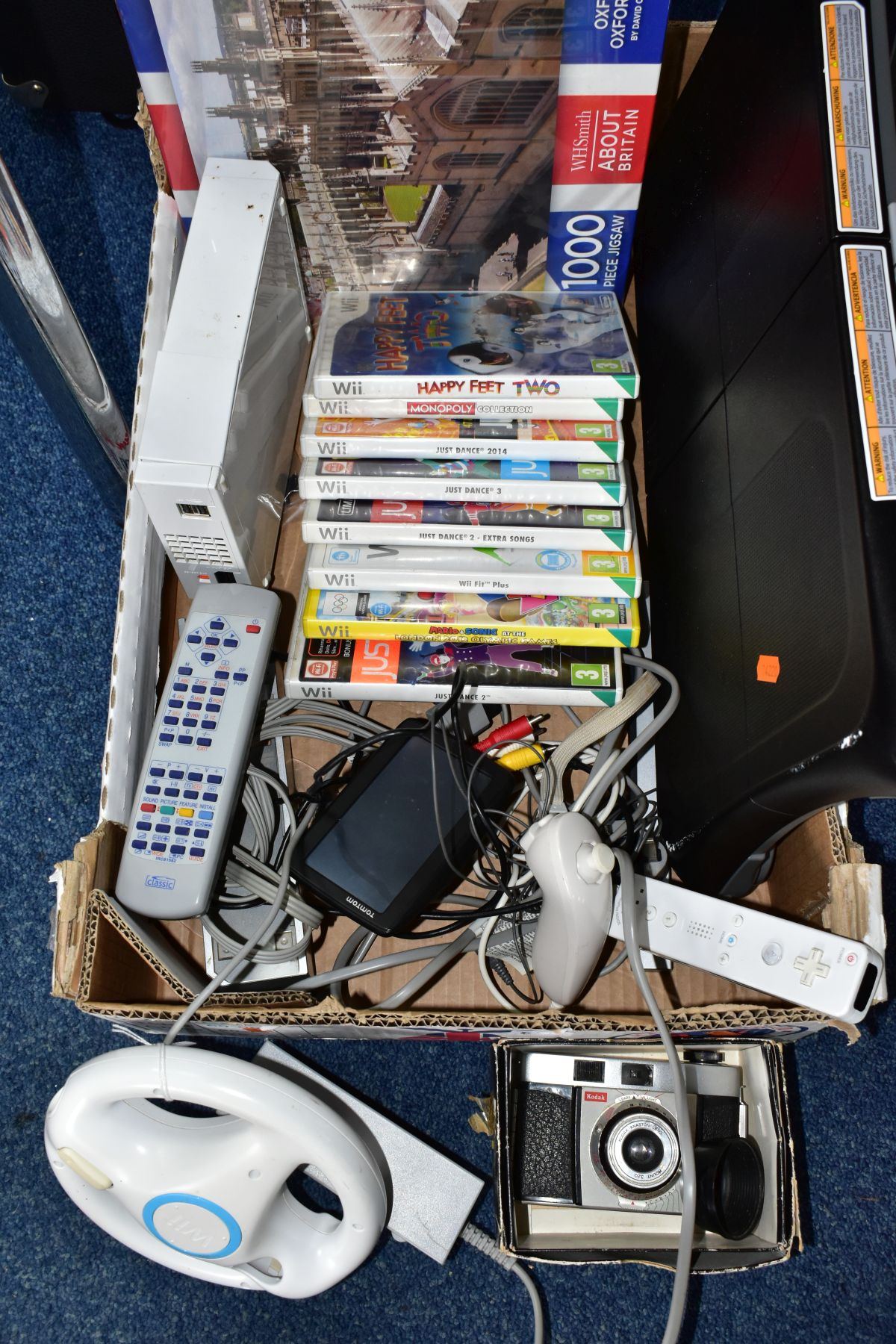 A NINTENDO WII CONSOLE, not tested, balance board, transformer, controllers, quantity of games