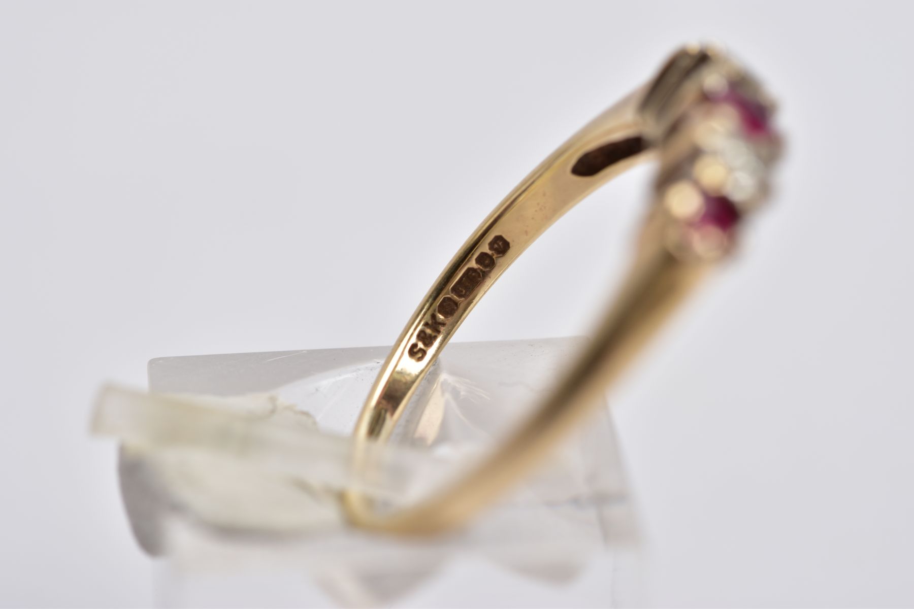 A 9CT GOLD RUBY AND DIAMOND RING, designed with three graduated circular cut rubies, interspaced - Image 3 of 4