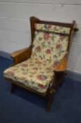 AN ARTS AND CRAFTS OAK ARMCHAIR, with open peg joints, and later cushions, width 73cm x inner seat