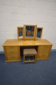 A SOLID GOLDEN OAK DRESSING TABLE with six drawers, separate triple bevelled edge dressing mirror