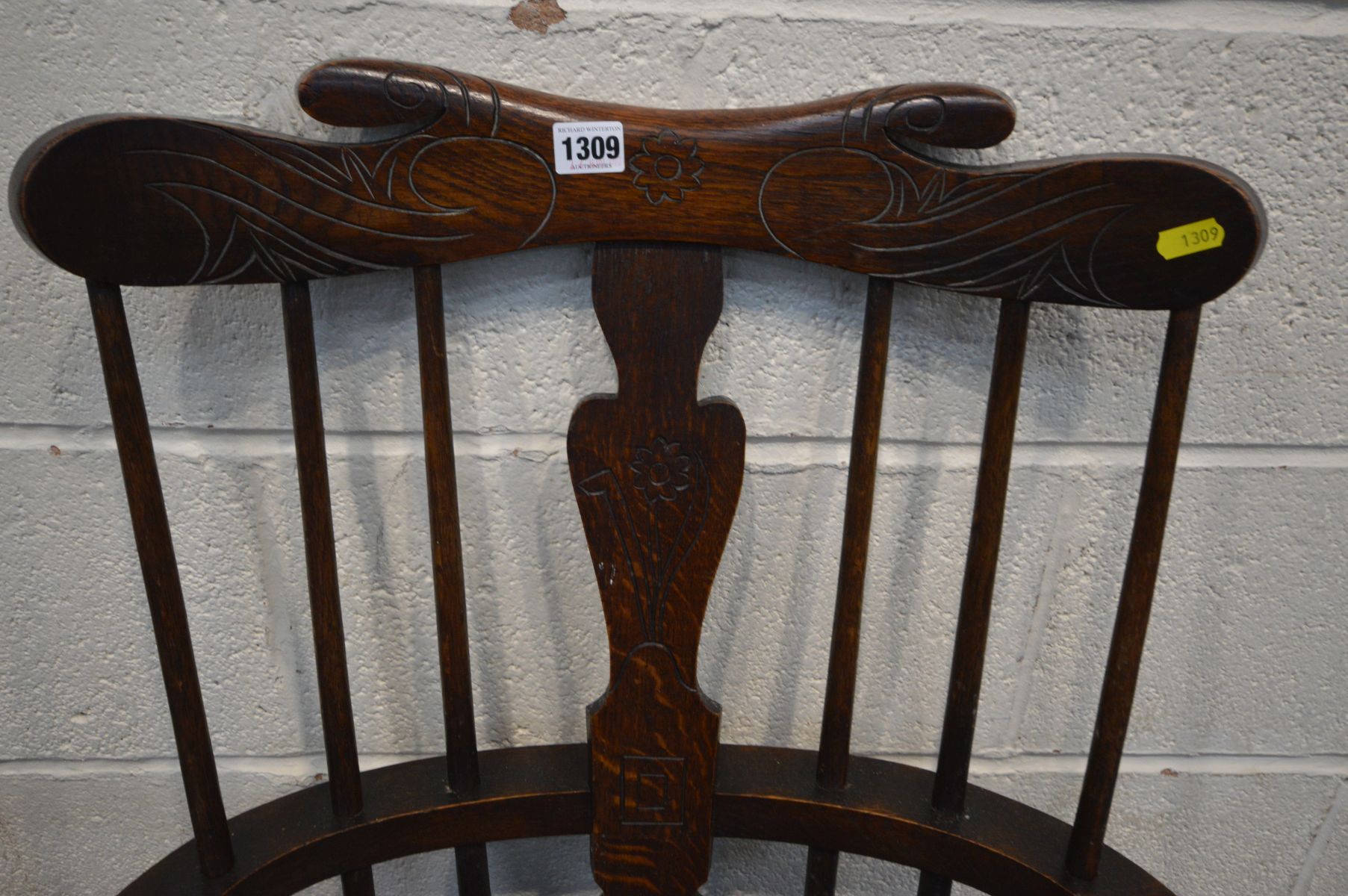 A 20TH CENTURY OAK COMB BACK WINDSOR ARMCHAIR, with carved decoration, along with a spinning - Image 3 of 4