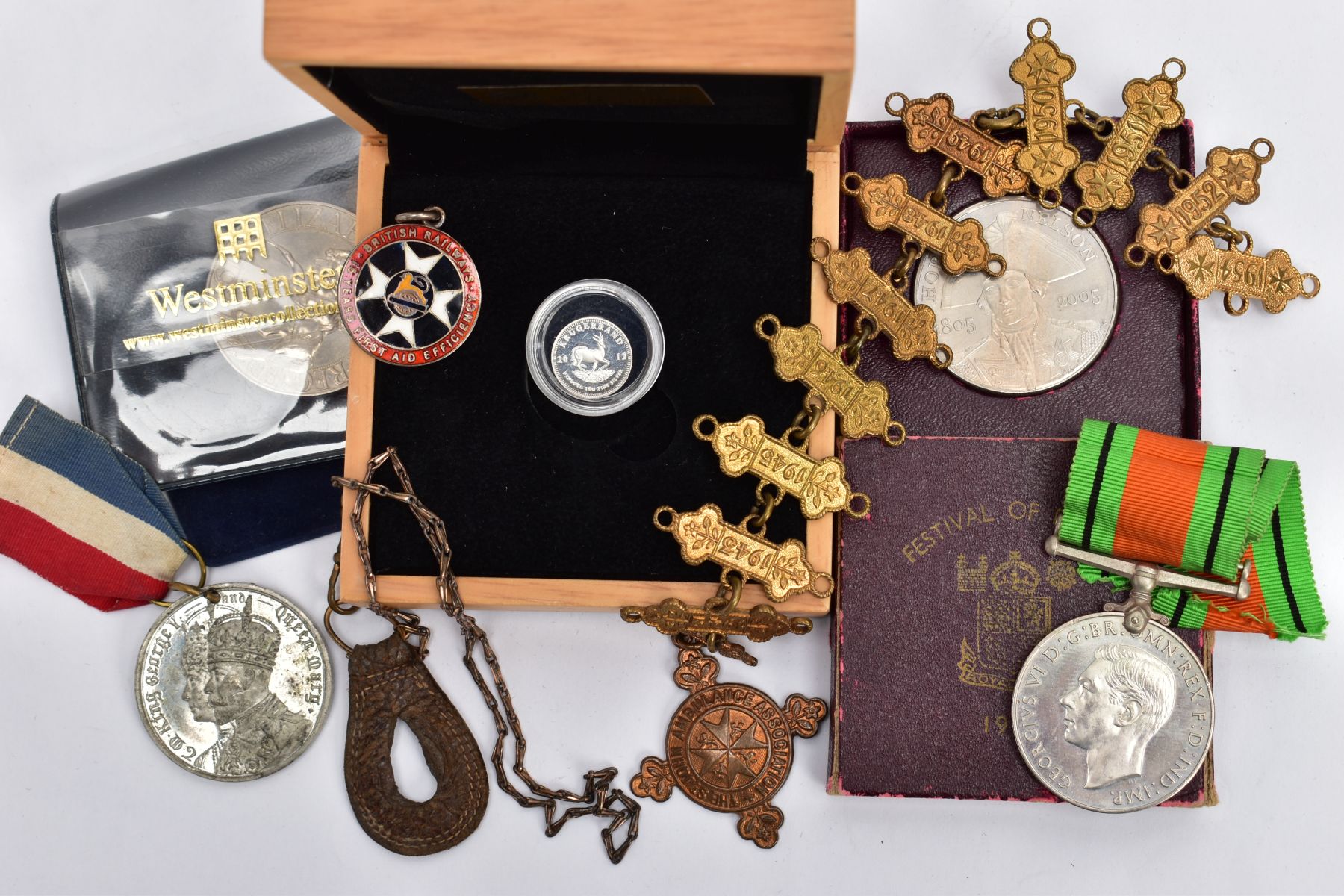A SMALL PACKET OF ITEMS to include a boxed 20th/ounce silver Krugerrand, a 12 year St Johns