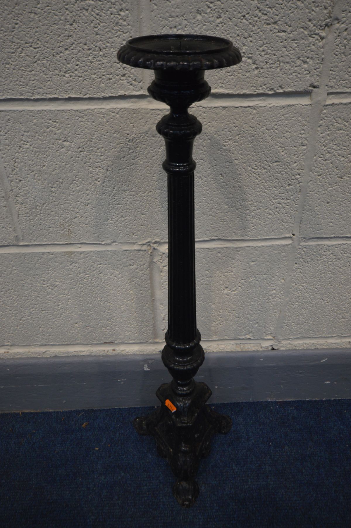 A BLACK PAINTED CAST IRON CANDLE STAND, height 70cm