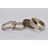 THREE SILVER BANGLES AND ONE OTHER, to include a wide hinged bangle with a decorative floral