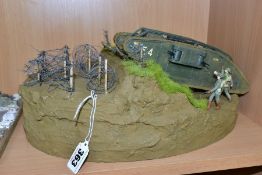 A DIORAMA OF A MK1 TANK CROSSING BARBED WIRE, approximate 1/32 scale, constructed plastic kit on a