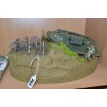 A DIORAMA OF A MK1 TANK CROSSING BARBED WIRE, approximate 1/32 scale, constructed plastic kit on a