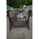 A STAINED TEAK SWING SEAT, bench length 122cm x frame length 154cm (paint partially peeling)