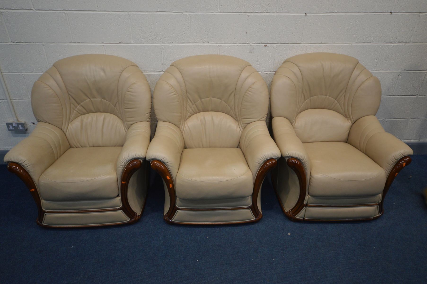 A RECLINING BIEGE LEATHER AND WOOD FRAMED MANUAL RECLINING ARM CHAIRS, and two matching armchairs (