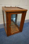 AN EARLY TO MID OAK JEWELLERY DISPLAY CABINET, with bevelled glass panels, mirror back and a