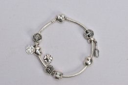 A PANDORA CHARM BRACELET, snake chain bracelet fitted with nine charms in forms such as an