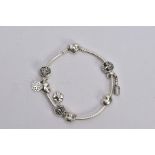 A PANDORA CHARM BRACELET, snake chain bracelet fitted with nine charms in forms such as an