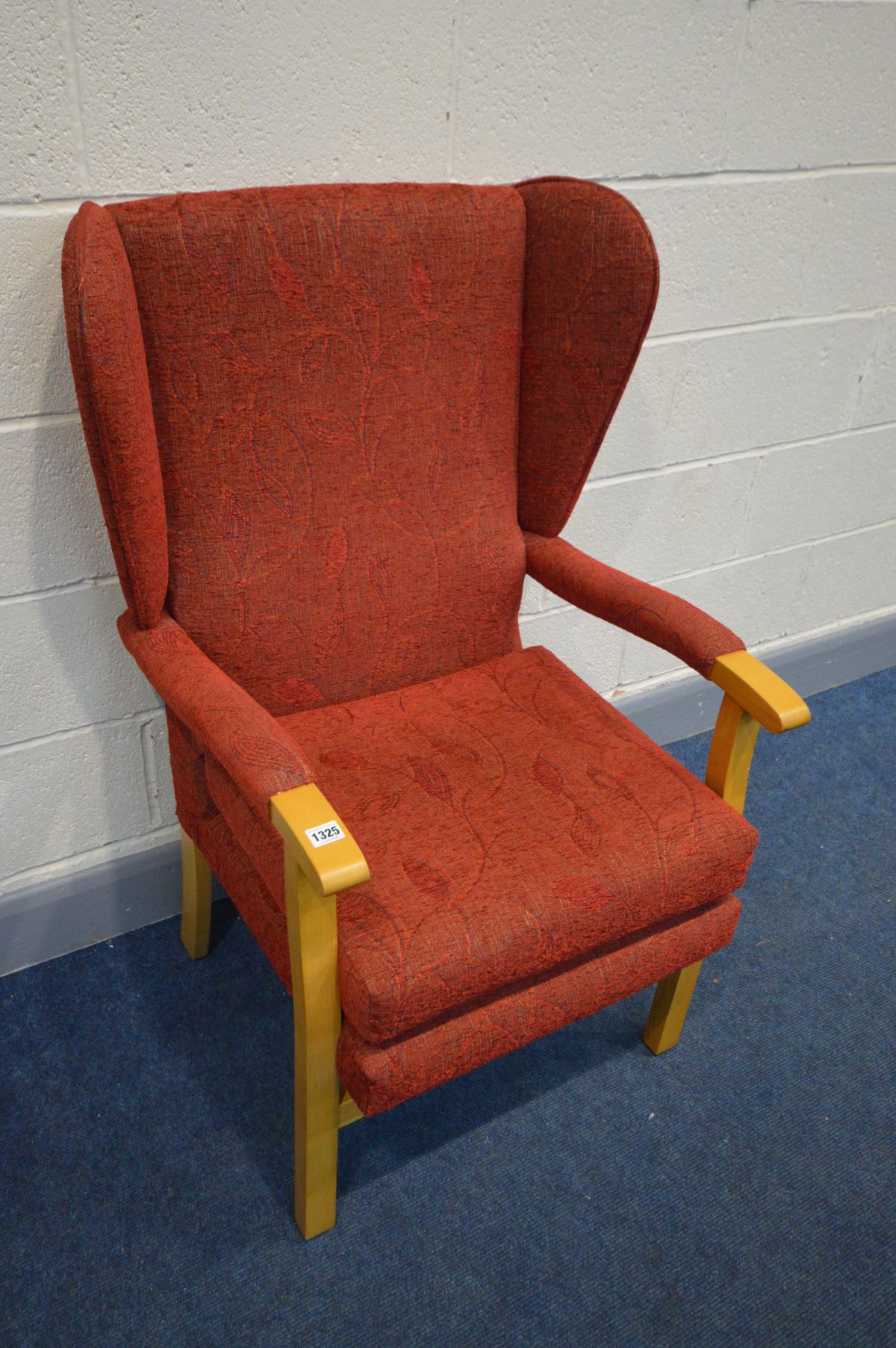 A MODERN WINGBACK ARMCHAIR on a beech frame