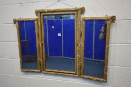 A LATE 19TH CENTURY GILT WOOD TRIPLE MIRROR, with rams head decoration, the central mirror that