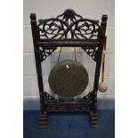 AN ORIENTAL KASHMIRI HARDWOOD DINNER GONG, with open fretwork depicting vines and leaves, along with