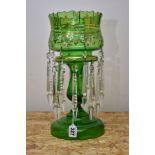 A LATE VICTORIAN GREEN GLASS LUSTRE, gilt foliate and white enamel decoration, with two tiers of