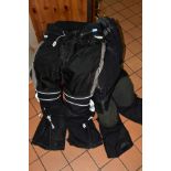 A PAIR OF TRIUMPH AIRFLOW TECH MOTORBIKE TROUSERS, a pair of AKITO motorbike trousers, a Simply