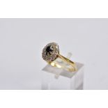 A YELLOW METAL SAPPHIRE AND DIAMOND CLUSTER RING, designed with a central oval cut blue sapphire,