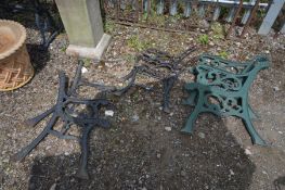 A PAIR OF CAST IRON GREEN PAINTED BENCH ENDS, along with two other pair of metal bench ends (3)