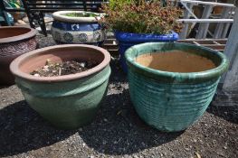 A GREEN GLAZED CIRCULAR GARDEN PLANTER with a rippled effect, diameter 52cm x height 40cm along with