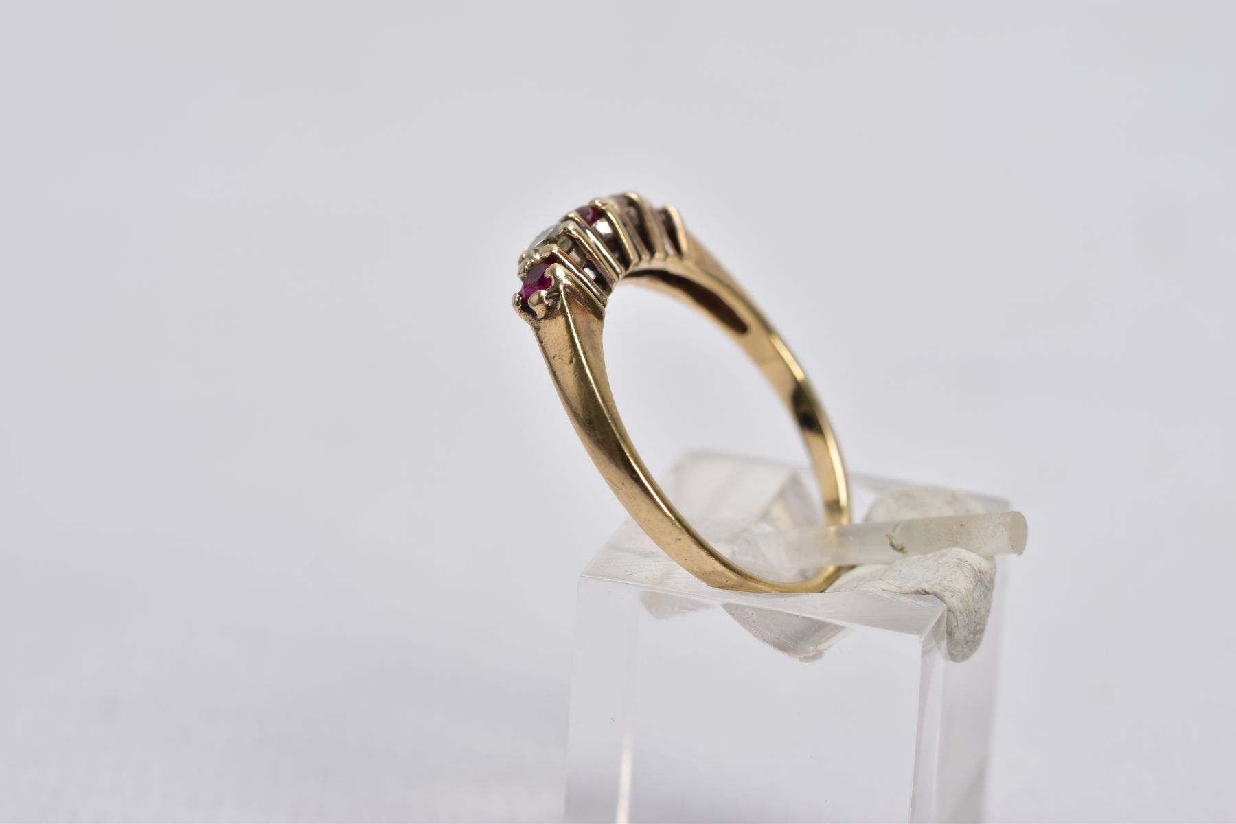 A 9CT GOLD RUBY AND DIAMOND RING, designed with three graduated circular cut rubies, interspaced - Image 2 of 4