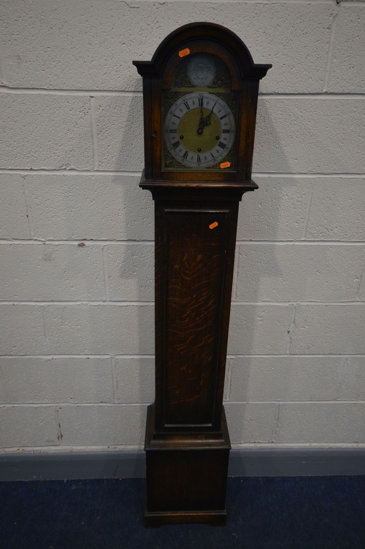 AN OAK GRANDDAUGHTER CLOCK, brass and silvered 6 inch dial with an Enfield movement, and tempus