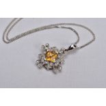 A WHITE METAL CITRINE AND DIAMOND PENDANT NECKLACE, the pendant centring on four square cut