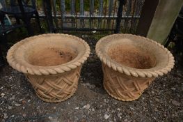 A PAIR OF COMPOSITE CIRCULAR PLANTERS with rope decoration to the top edge and lattice work