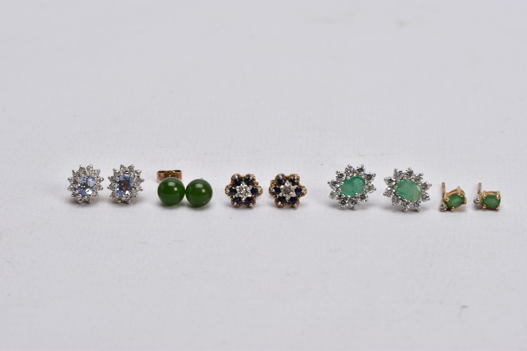 FIVE PAIRS OF GEM SET EARRINGS, to include a pair of emerald and diamond stud earrings, missing