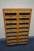 A BEECH HABERDASHERY CABINET, made up of sixteen glass fronted drawers and silvered handles, width