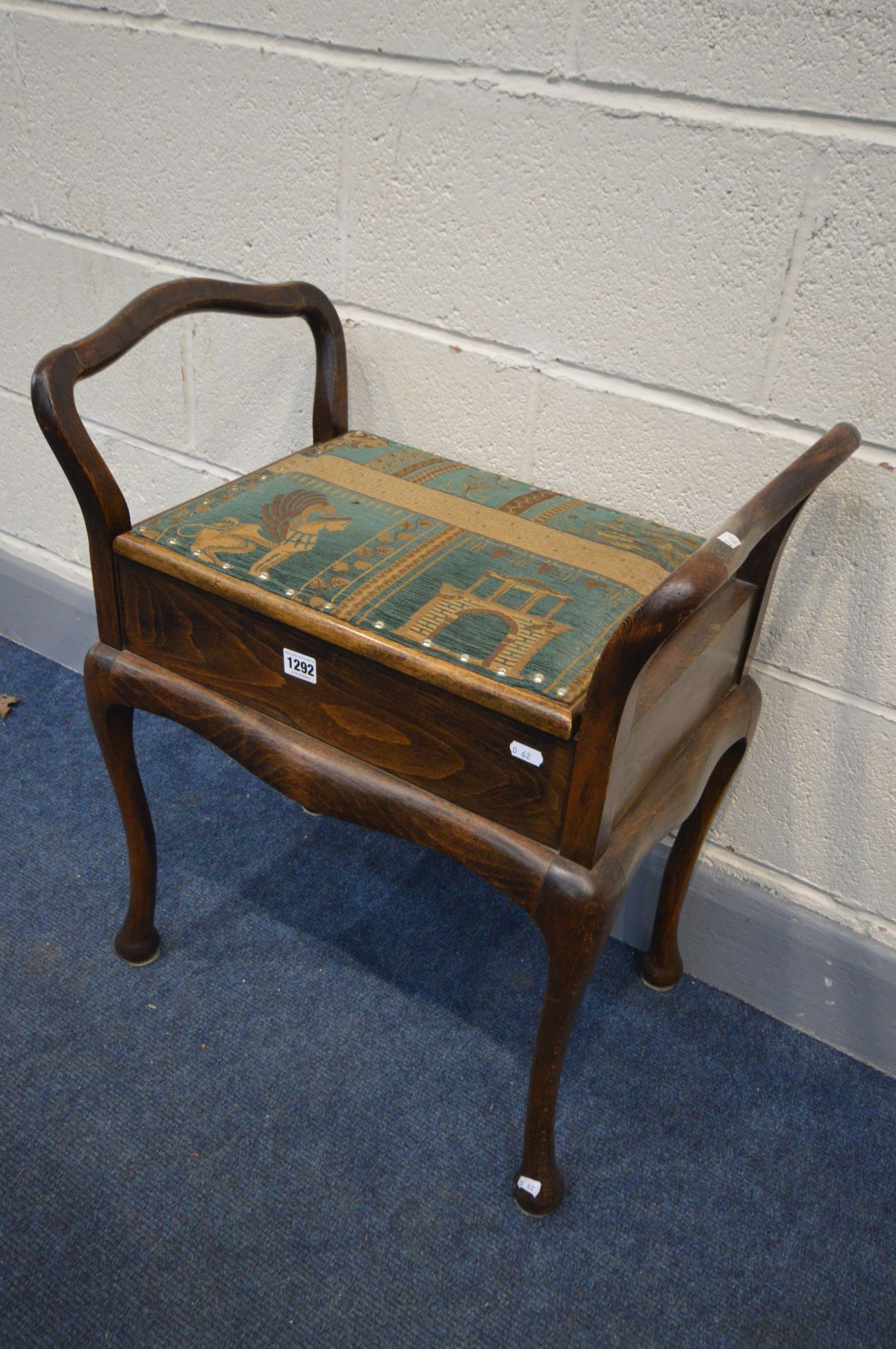 A BEECH PIANO STOOL with shaped arms