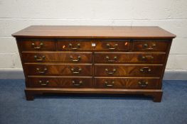 A REPRODUX MAHOGANY AND CROSSBANDED SIDEBOARD/CHEST OF NINE ASSORTED DRAWERS, with drop handles