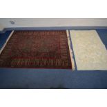 A WOOLLEN CARPET SQUARE, of an unusual design, red field and green pattern, 240cm x 170cm, label