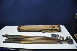A VINTAGE GOLF BAG AND CLUBS including three hickory shafted drivers, two A. Matthews Hickory