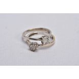 TWO DIAMOND RINGS, the first a white gold ring, designed with a raised illusion set, round brilliant