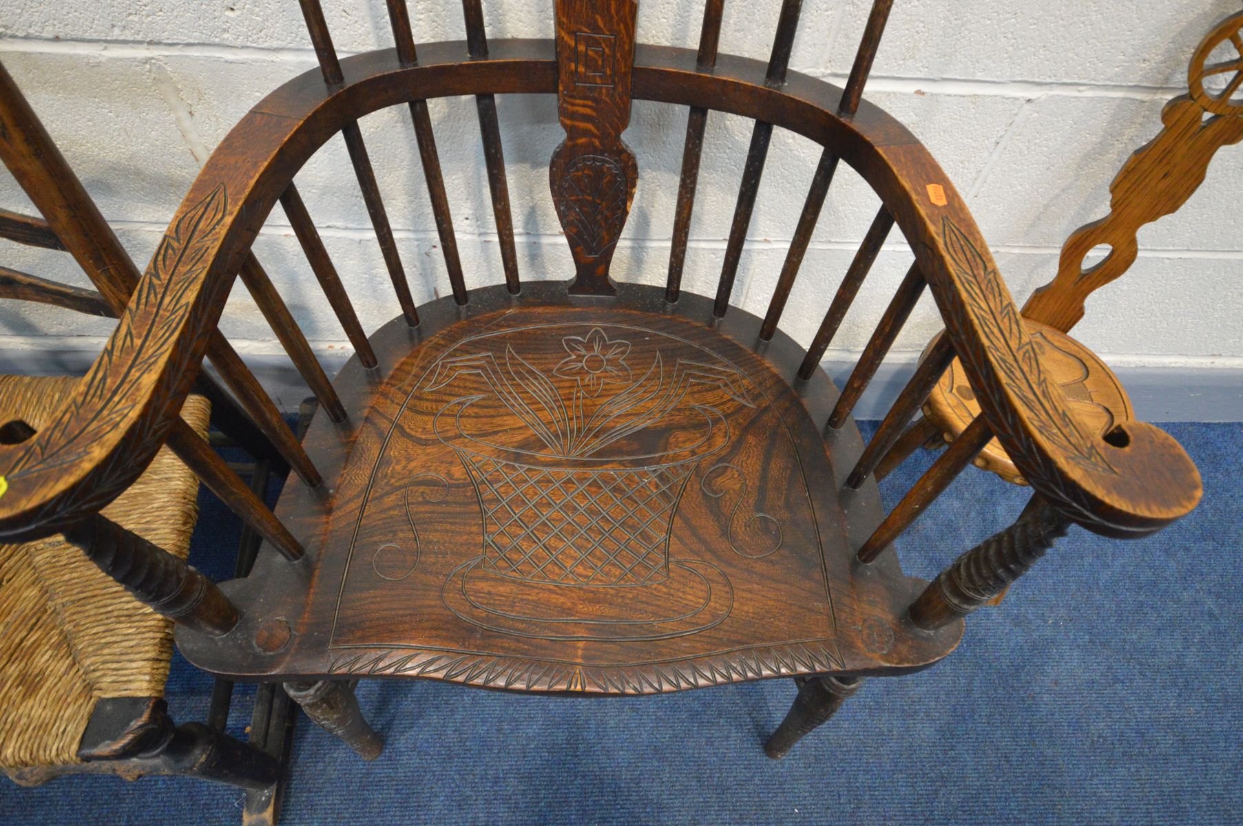 A 20TH CENTURY OAK COMB BACK WINDSOR ARMCHAIR, with carved decoration, along with a spinning - Image 4 of 4