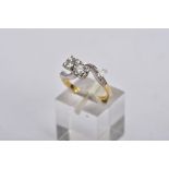 AN 18CT GOLD DIAMOND CROSS OVER RING, designed with two asymmetrical set round brilliant cut