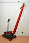 A CHILD'S RED, GREEN AND BLACK PAINTED WOODEN AND METAL CRANE, with operational parts and in working
