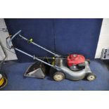 A HONDA i2Y PETROL SELF PROPELLED LAWN MOWER with grass box ( engine pulls freely but hasn't been