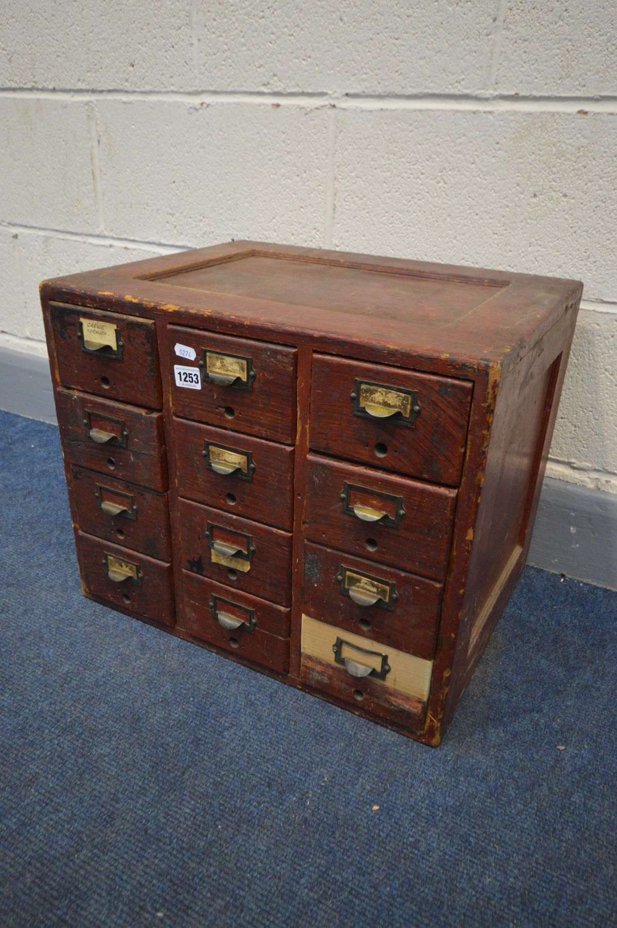 A VINTAGE STAINED PINE TWELVE DRAWER INDEX CABINET, width 51cm x depth 40cm x height 43cm (repair to