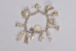A HEAVY SILVER CHARM BRACELET, each link stamped with a lion passant, suspending thirteen charms, in