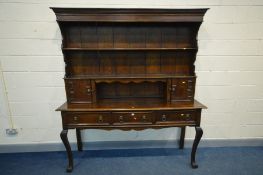 AN EARLY 20TH CENTURY OAK DRESSER, the married top with two flanked single drawer cupboards above