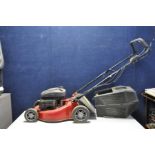 A CHAMPION SELF PROPELLED PETROL LAWN MOWER with grass box (engine pulls freely but hasn't been