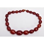 A CHERRY AMBER GRADUATED BEAD NECKLACE, the largest measuring approximately 31.7mm x 23.3mm, the