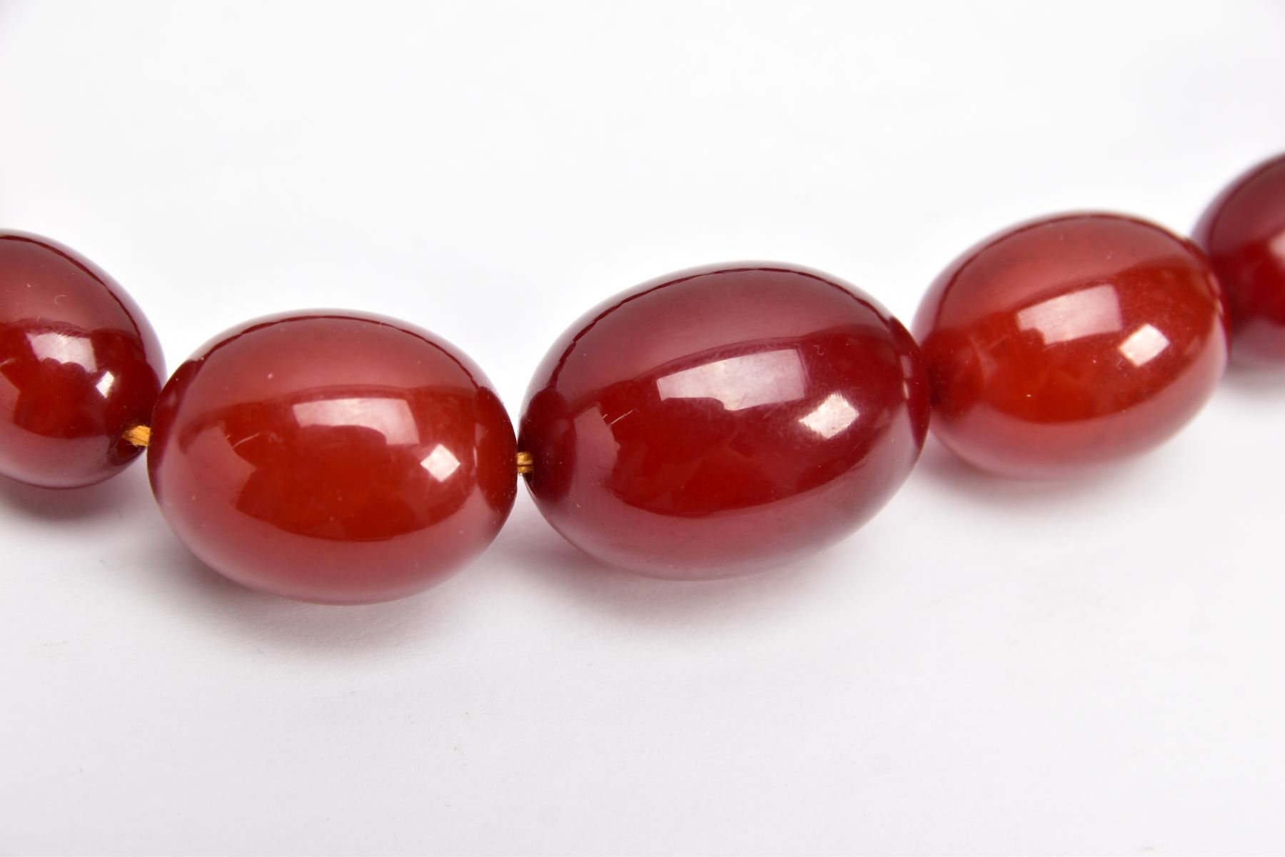 A CHERRY AMBER GRADUATED BEAD NECKLACE, the largest measuring approximately 31.7mm x 23.3mm, the - Image 2 of 4