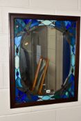 A WOOD FRAMED TIFFANY STYLE WALL MIRROR, the central mirror panel is surrounded by a repeat